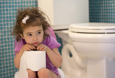 little girl sitting on the potty in the bathroom